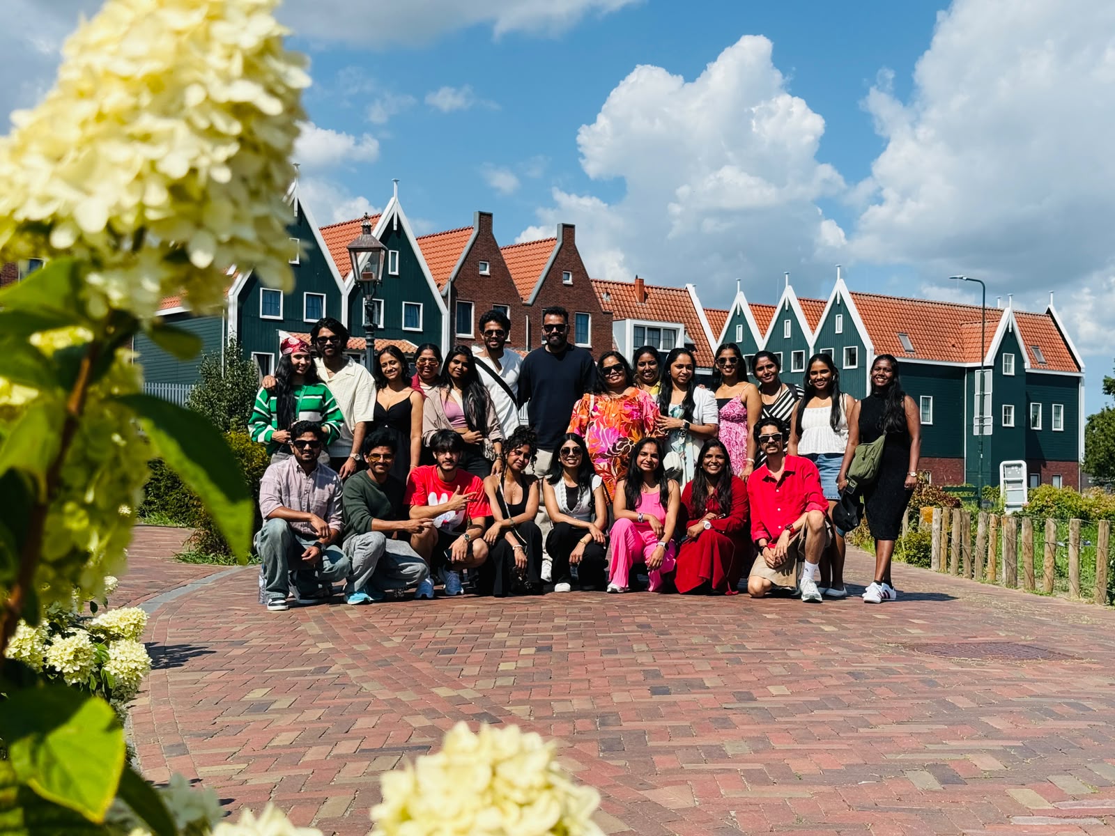 Europe on Wheels group in front of the traditional green houses of Volendam